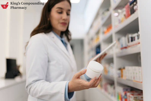 Pharmacist checking a medicine bottle on a shelf