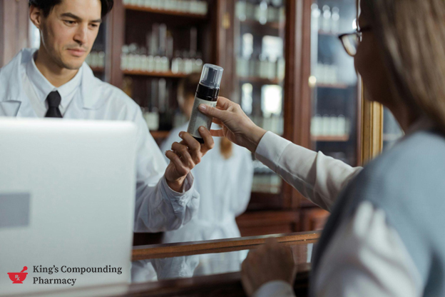 Pharmacist assisting a customer with medication questions at the pharmacy counter