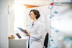 Pharmacist reviewing medication information inside a pharmacy setting